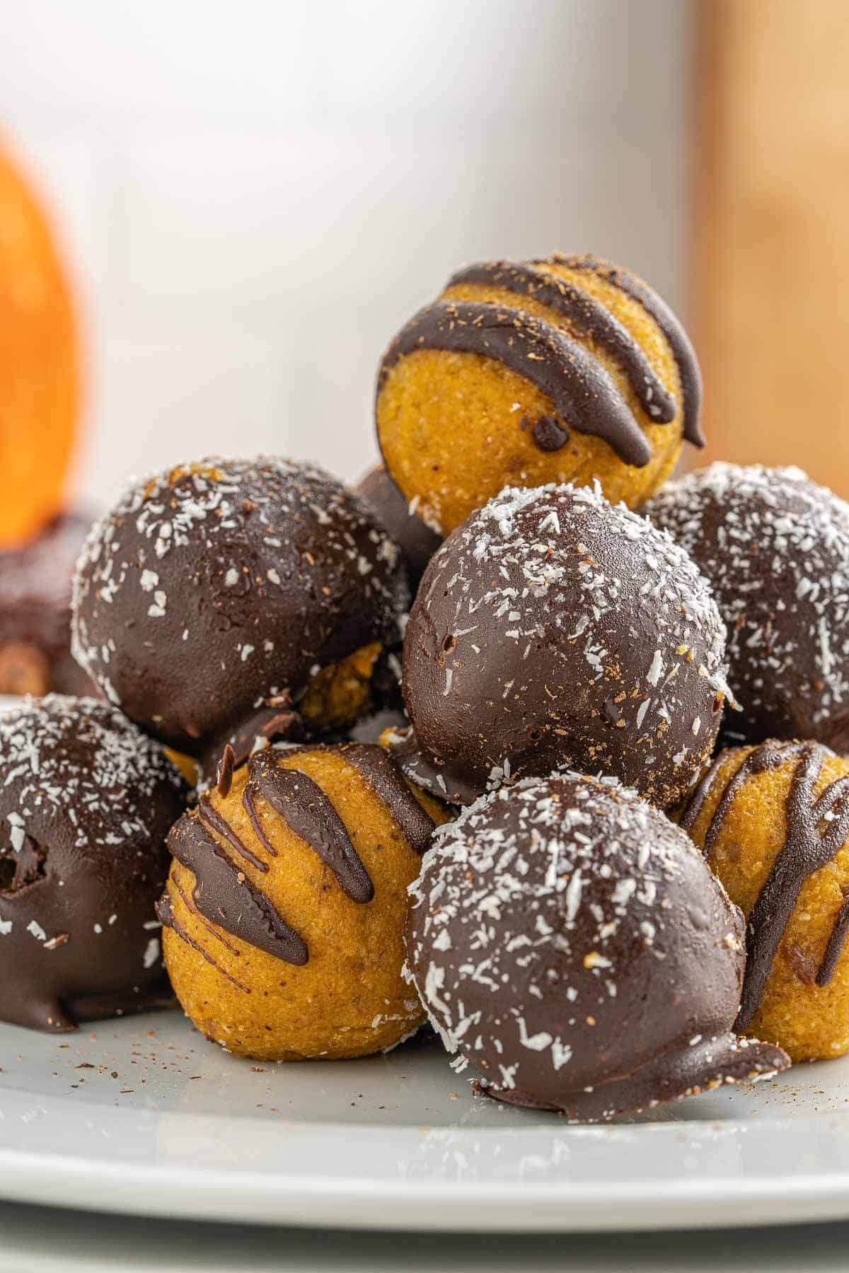 Dark Chocolate pumpkin truffles stacked on a plate