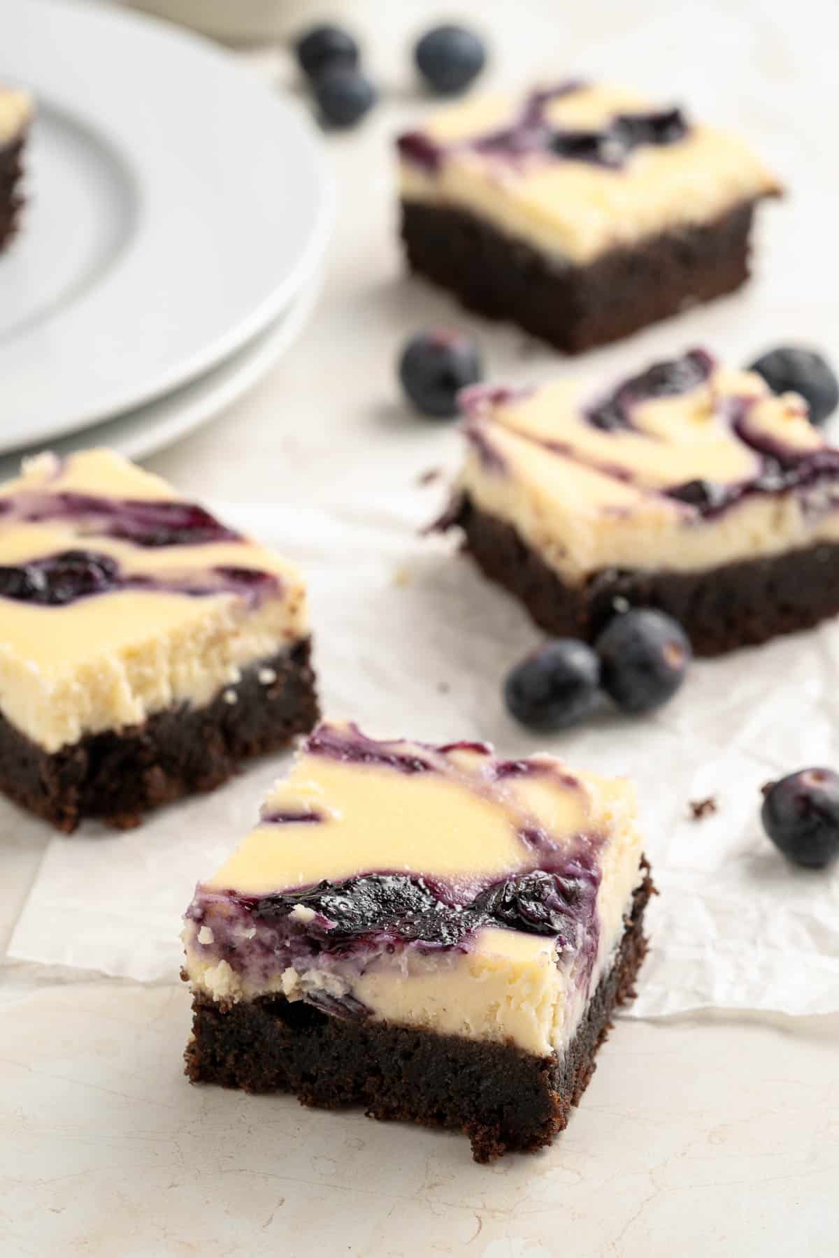 a single cheesecake brownie on parchment paper