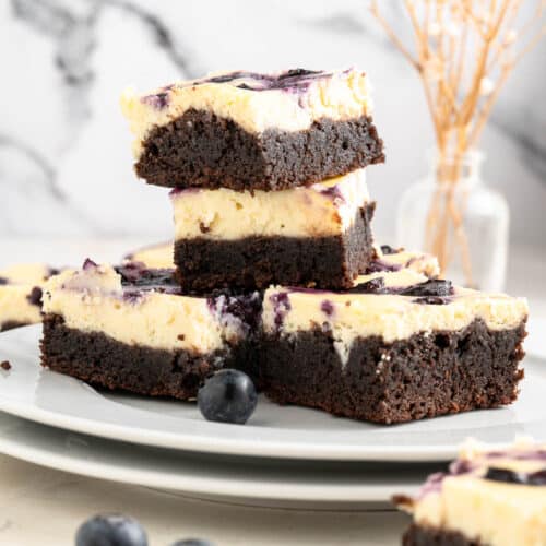 fudgy blueberry cheesecake brownies in a stack of 4