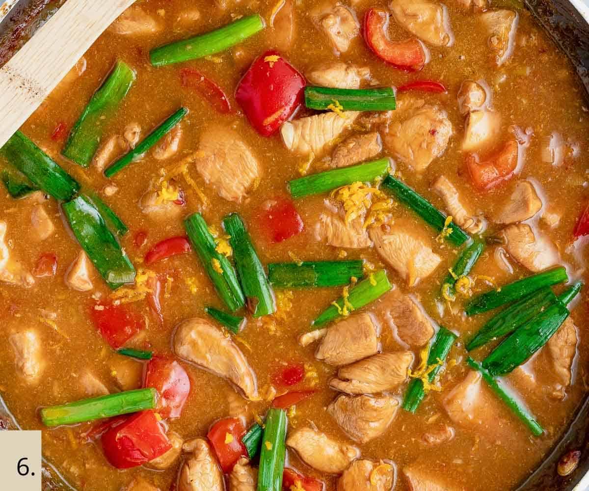 healthy chinese orange chicken cooking in a skillet