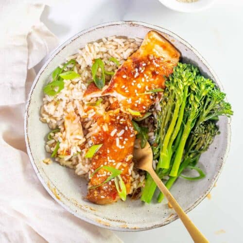 brocolini and salmon in a bowl with rice