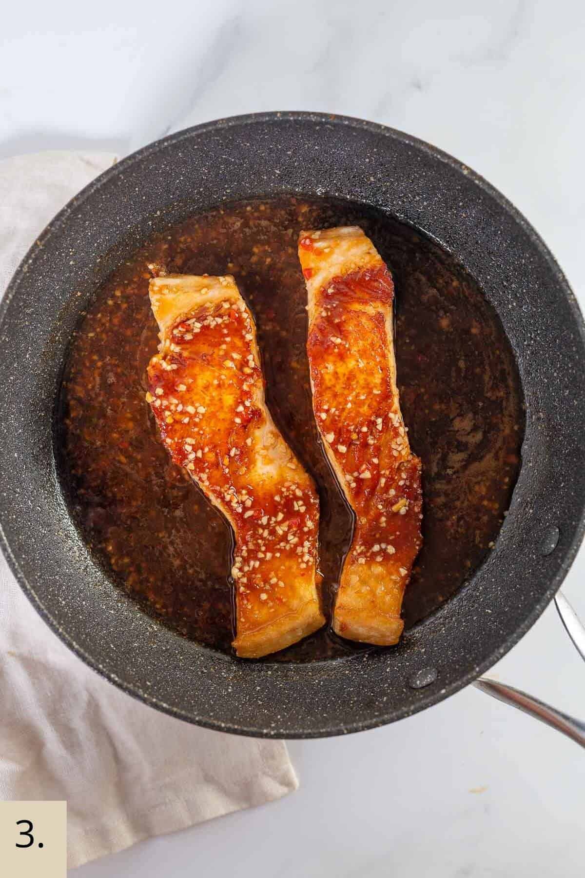 cooked glazed salmon in a pan