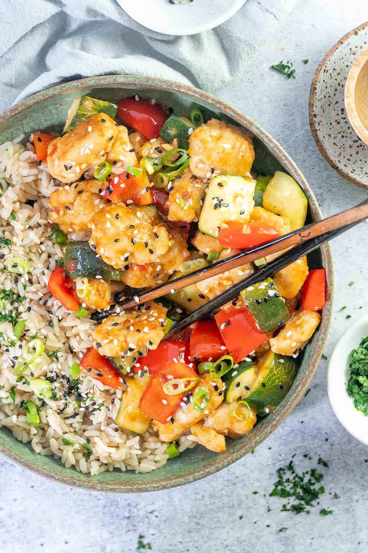 green bowl with sweet chilli chicken and rice