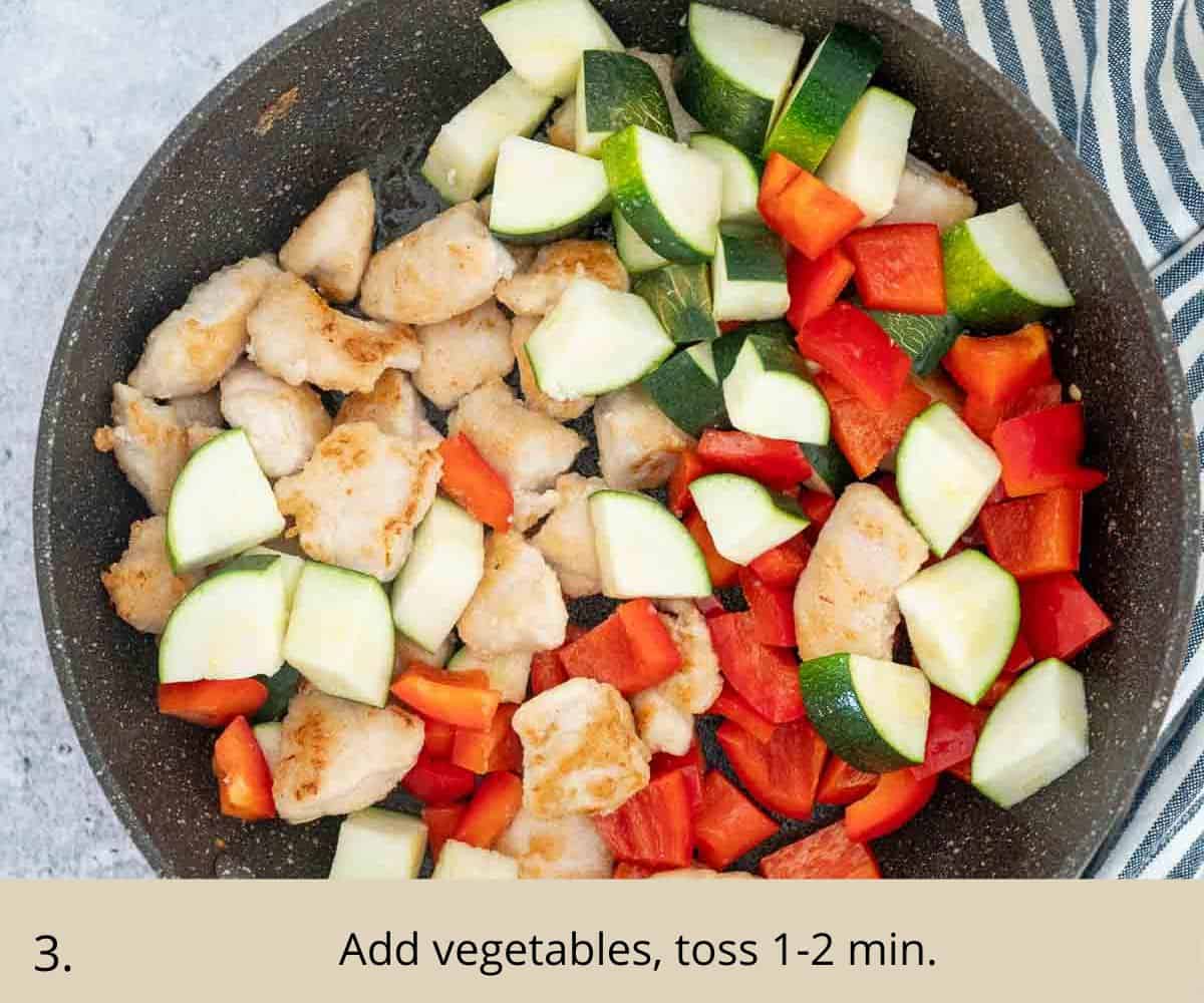 Cooking chicken pieces and chopped vegetables in a skillet