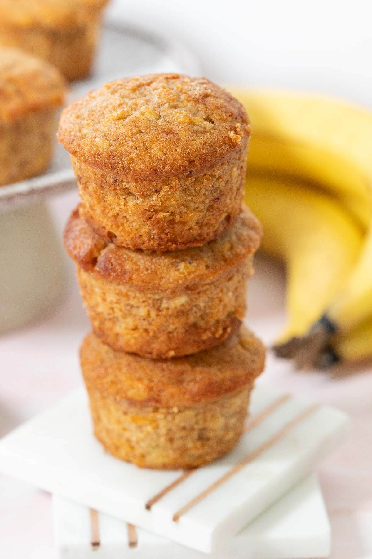 a stack of 3 banana carrot muffins