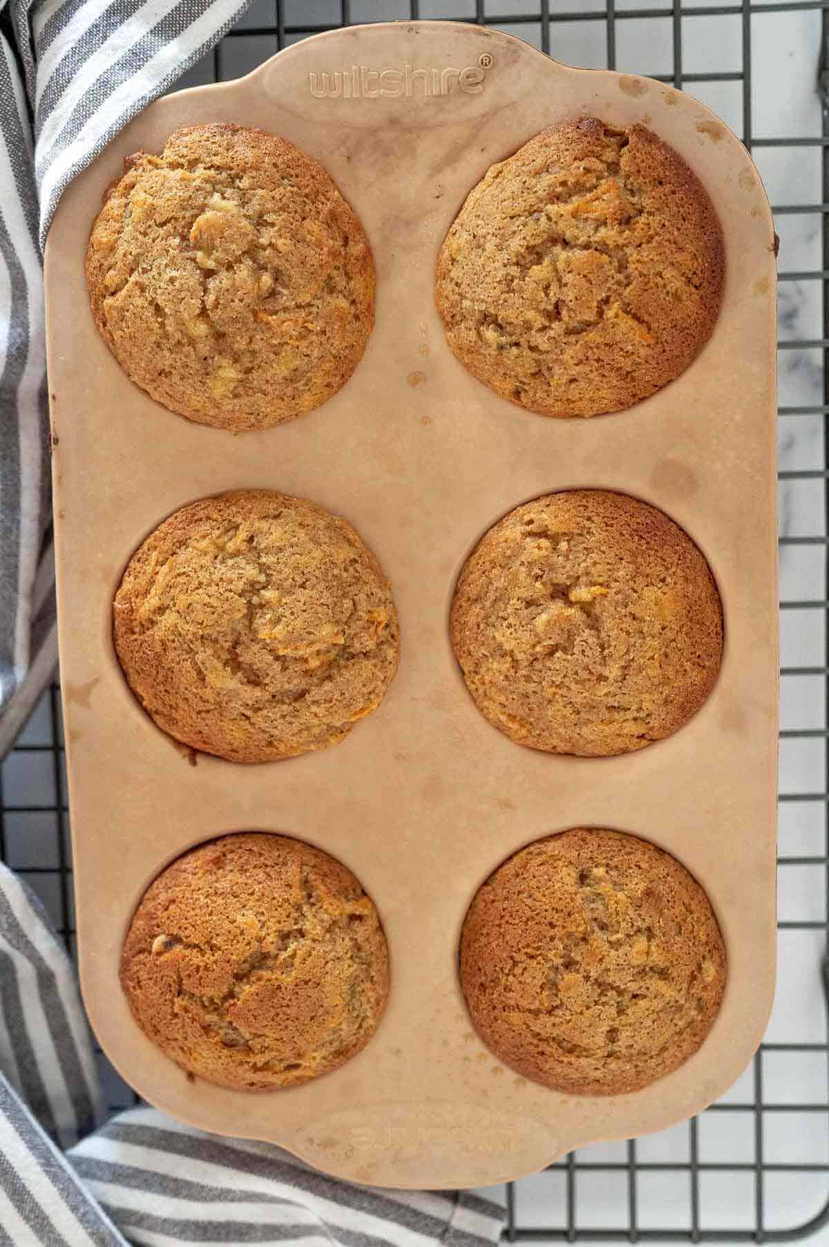 banana carrot muffins cooked and in muffin tray