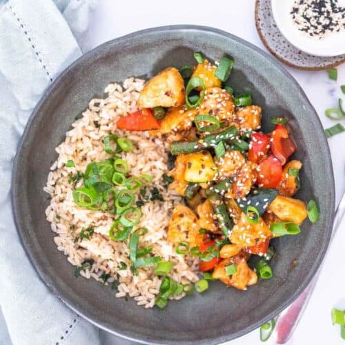 mongolian chicken with rice in a grey bowl