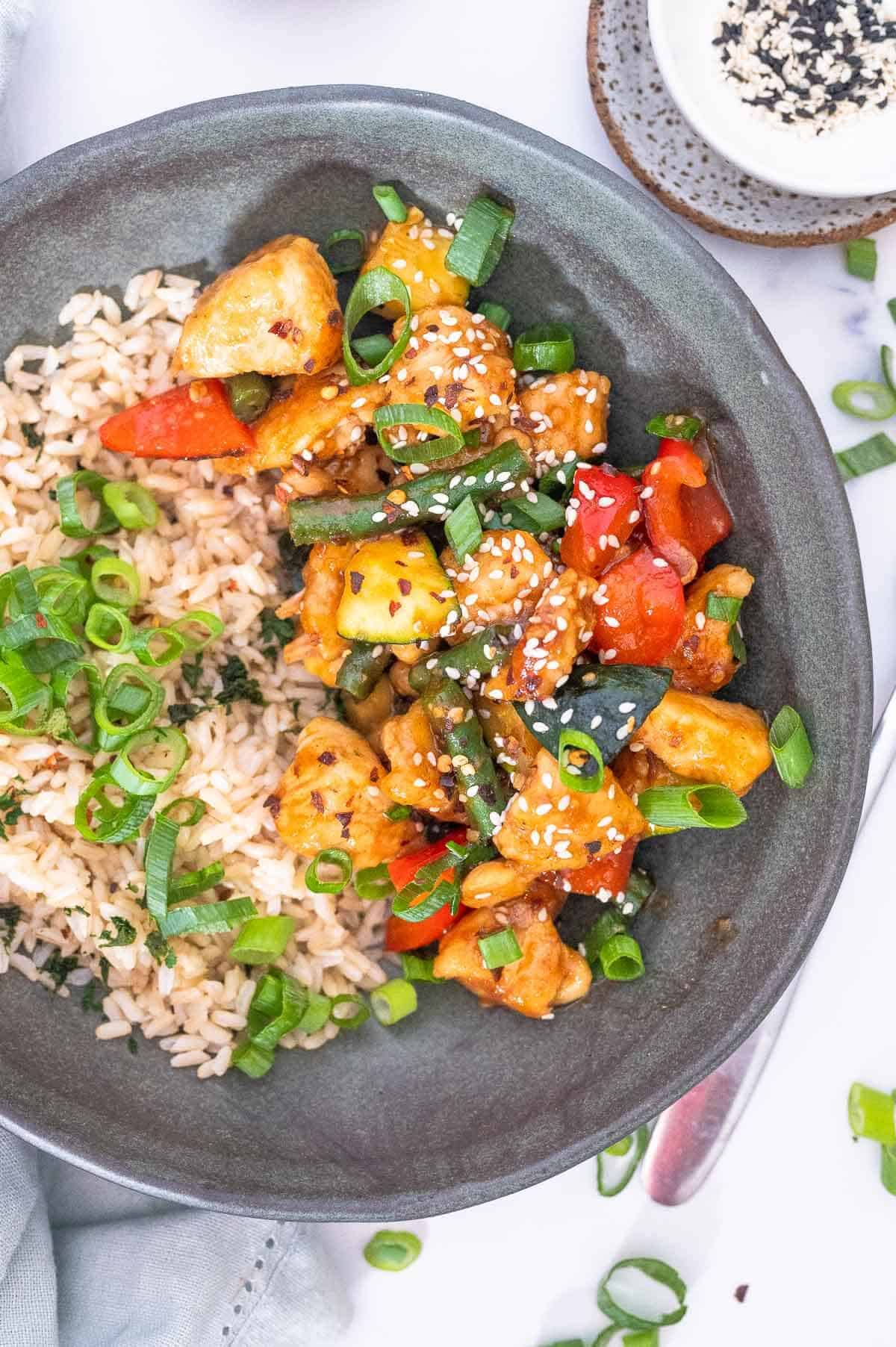 mongolian chicken and rice in a bowl ready to eat