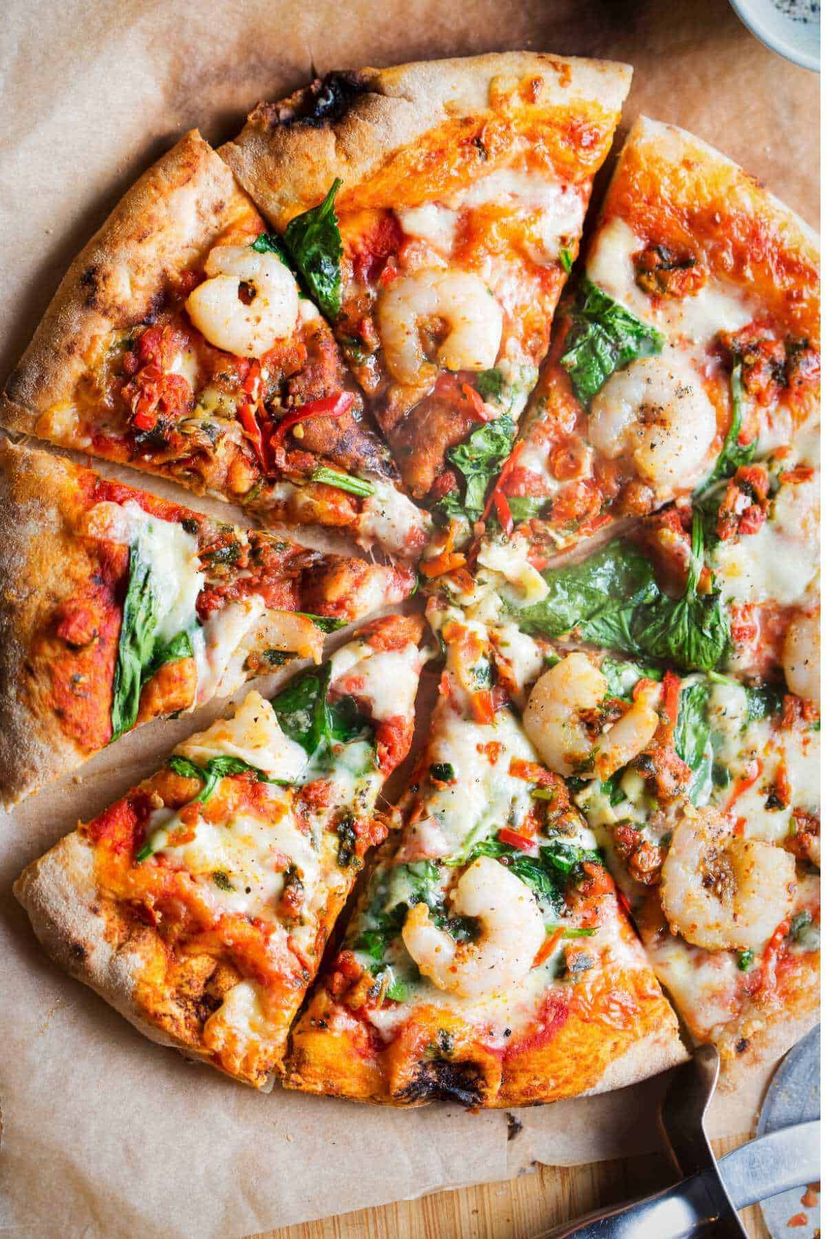 slices of garlic prawn pizza on a board