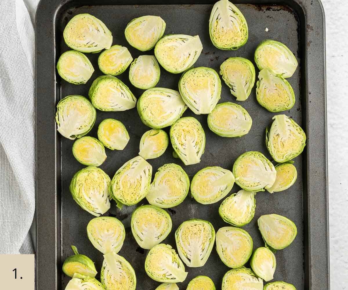 uncooked halved brussel sprouts on a baking tray