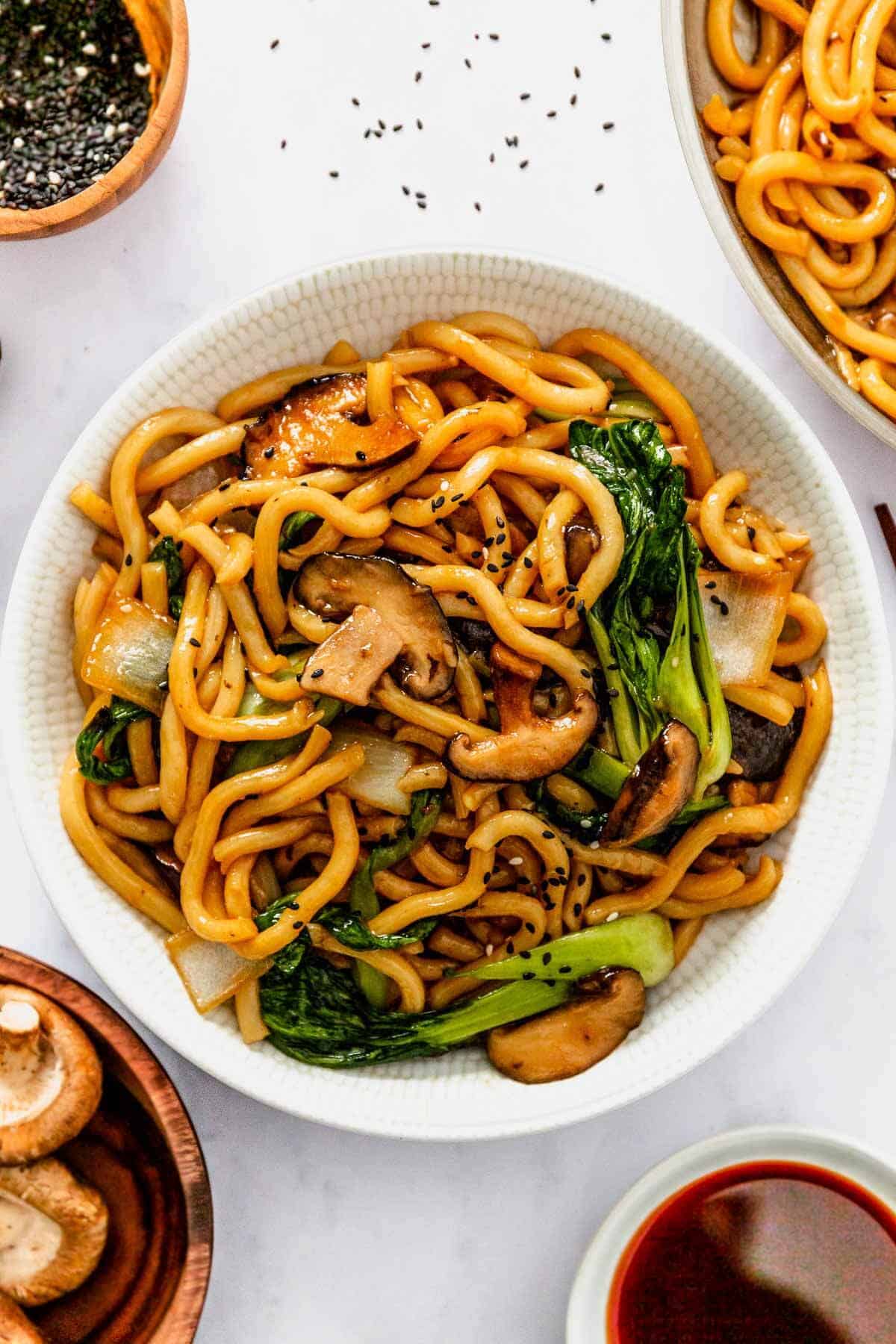 a bowl of yaki soba noodles garnished with sesame seeds