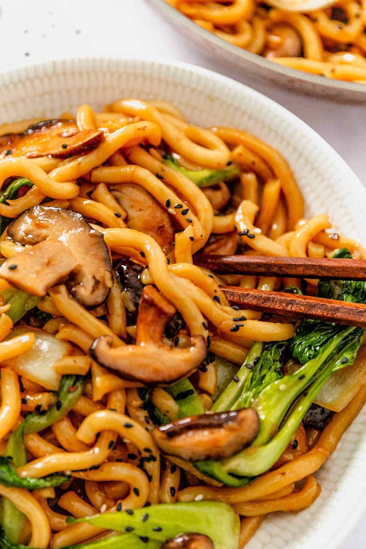 yaki soba noodle bowl with chopsticks dug in