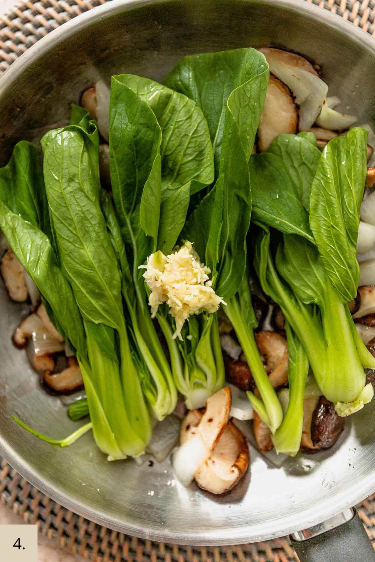 mushroom, bok choy and garlic in a frying pan