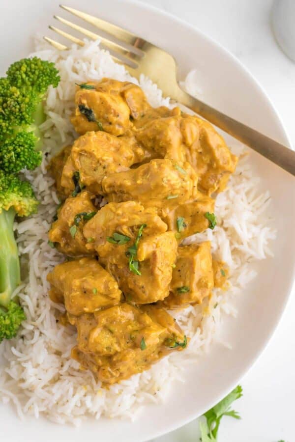 chicken curry, rice and broccoli on a plate