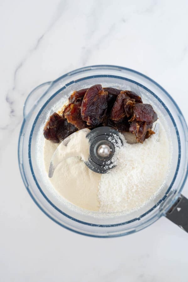 dates, coconut and protein powder in a food processor