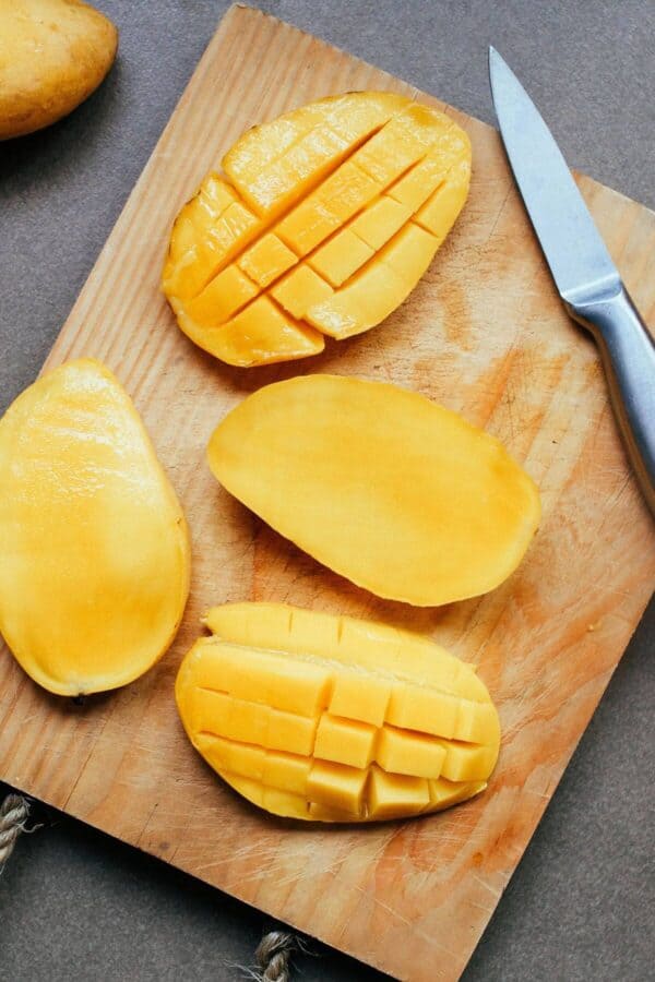 dicing a mango cheek on a cutting board