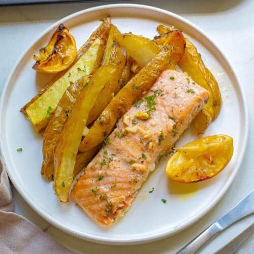 lemon garlic salmon potatoes on a white plate