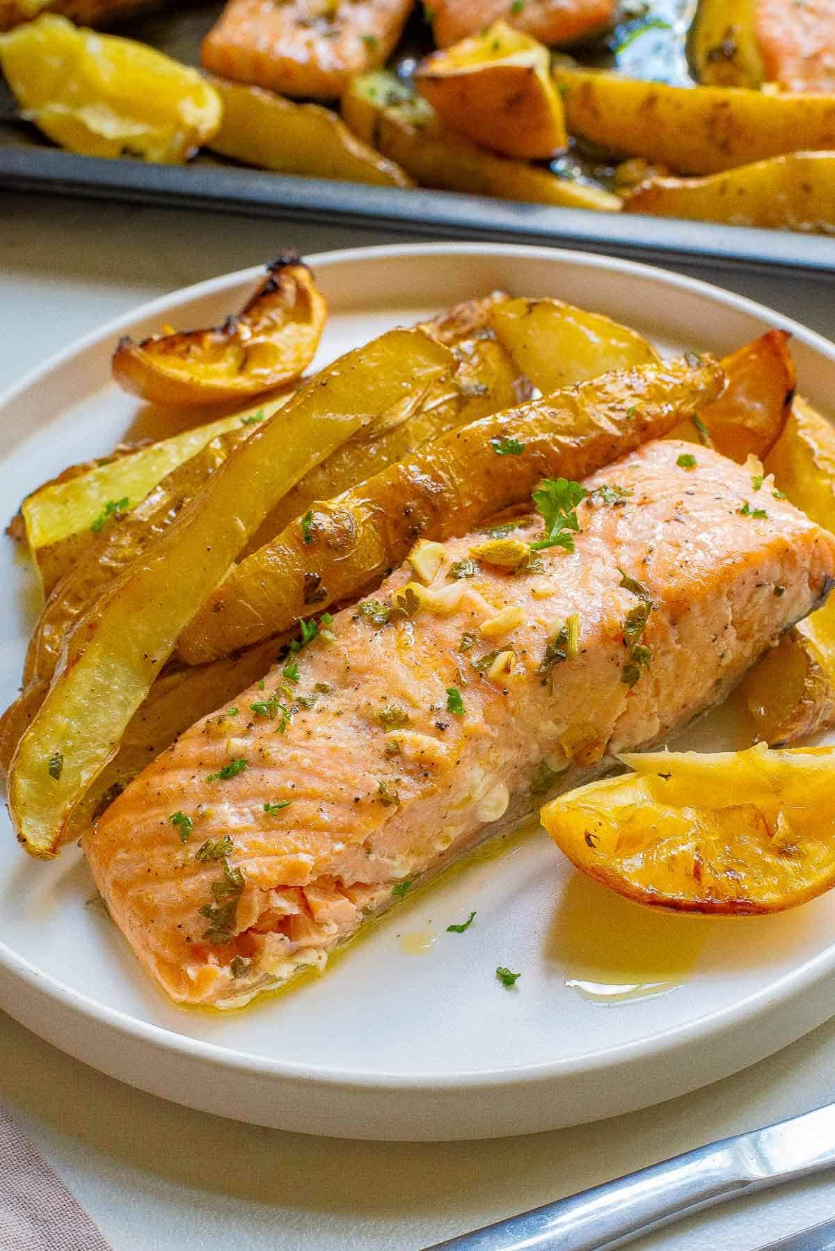 a plate of baked potato and garlic lemon salmon