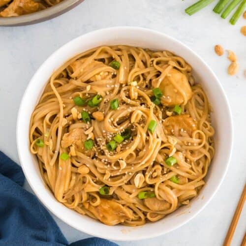 Creamy peanut sauce and rice noodles with chicken in a bowl