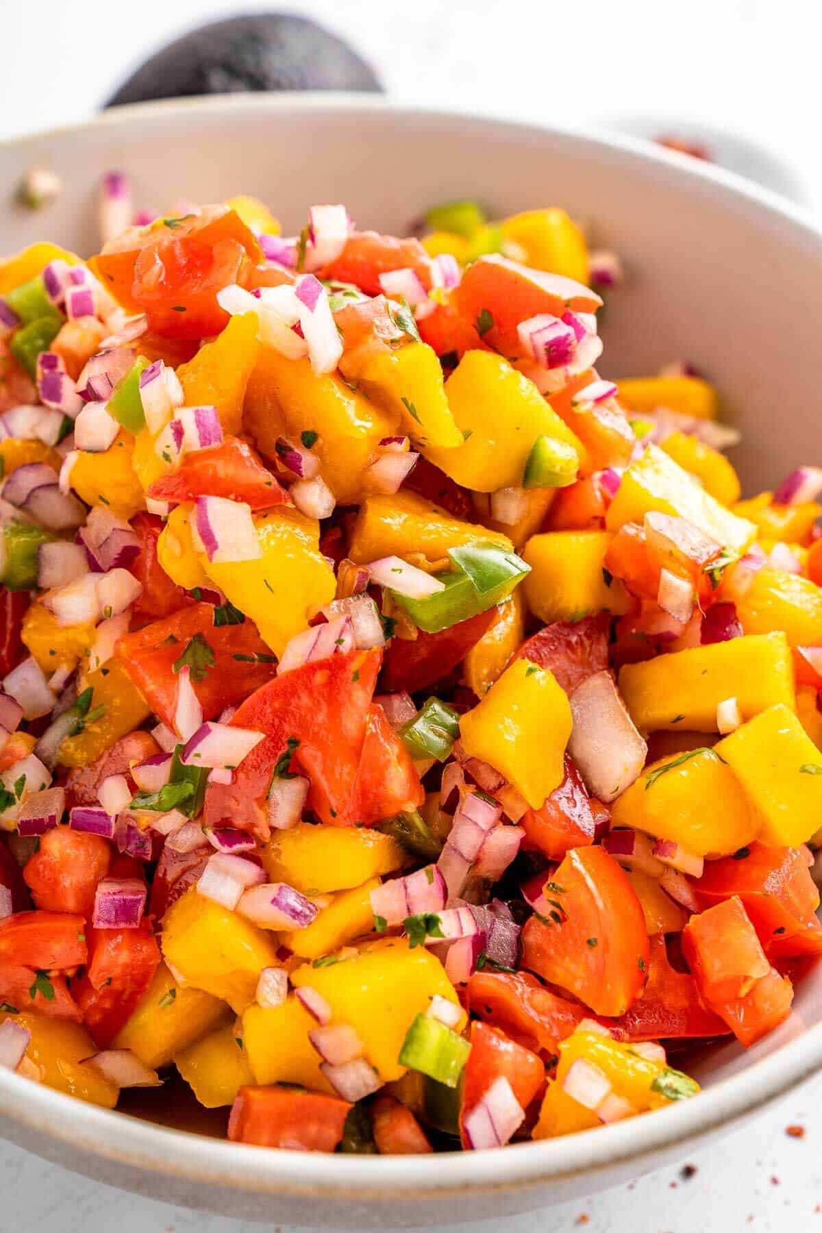 close up of sweet and spicy jalapeno mango tomato salsa