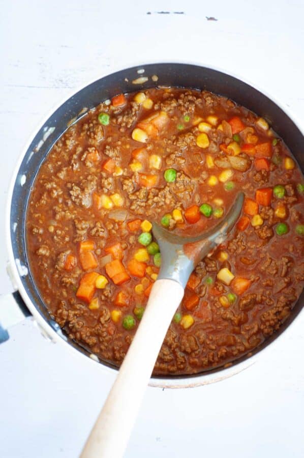 spicy ground beef curry in a pot with spoon