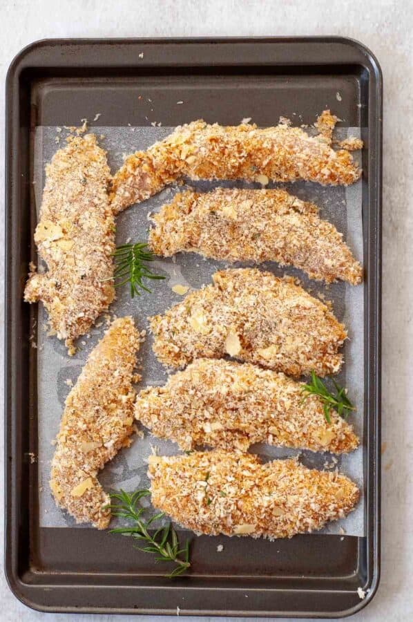 panko chicken fingers on a baking sheet