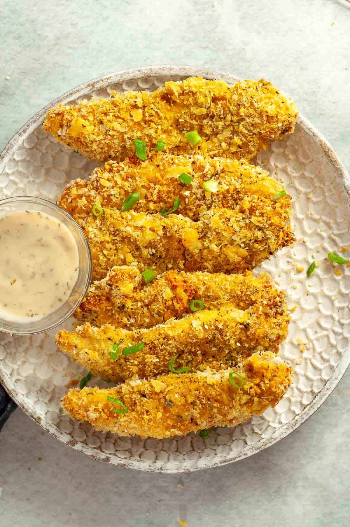 panko breadcrumb chicken tenders on a serving plate