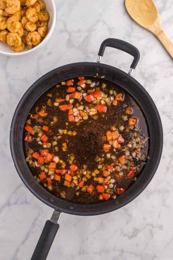 oil, onion, garlic and capsicum frying in a pan