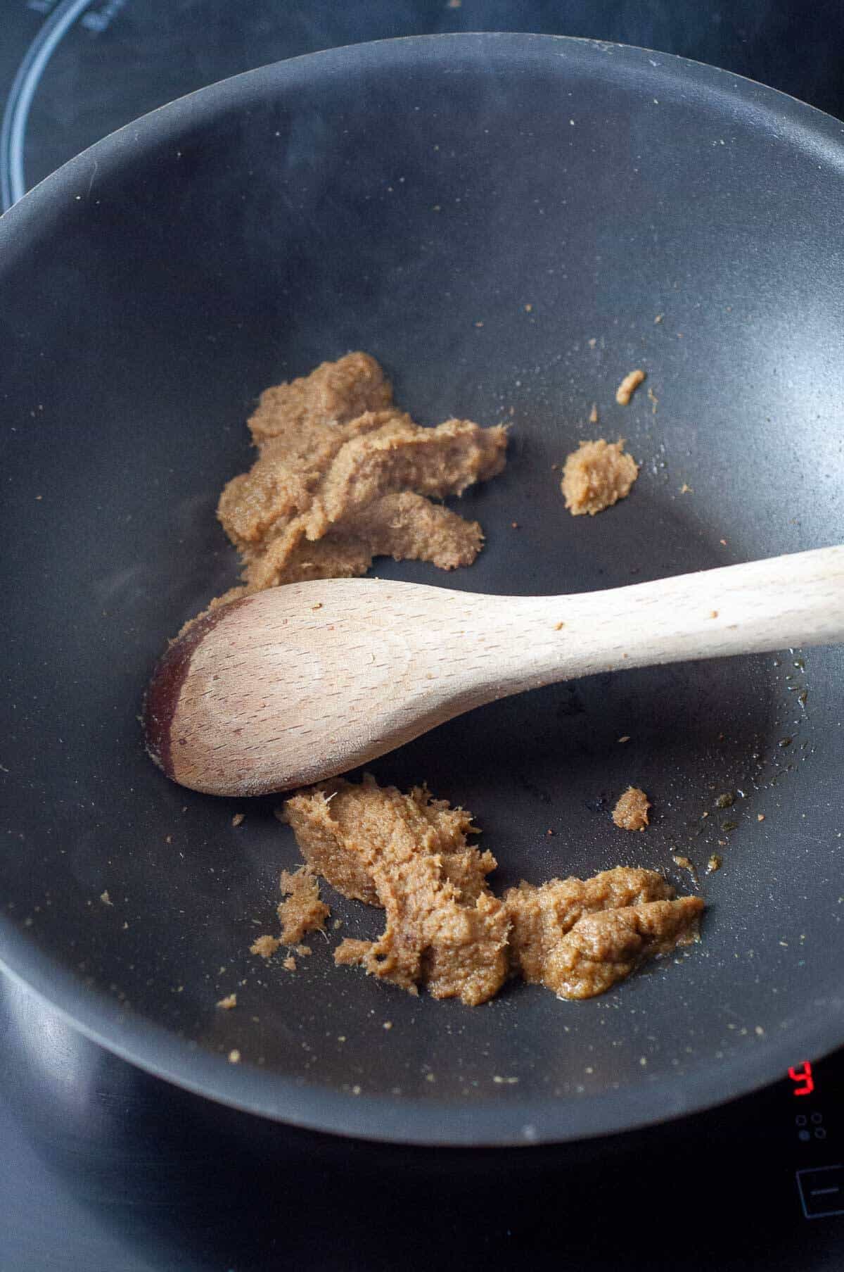 cooking off curry paste in a pan