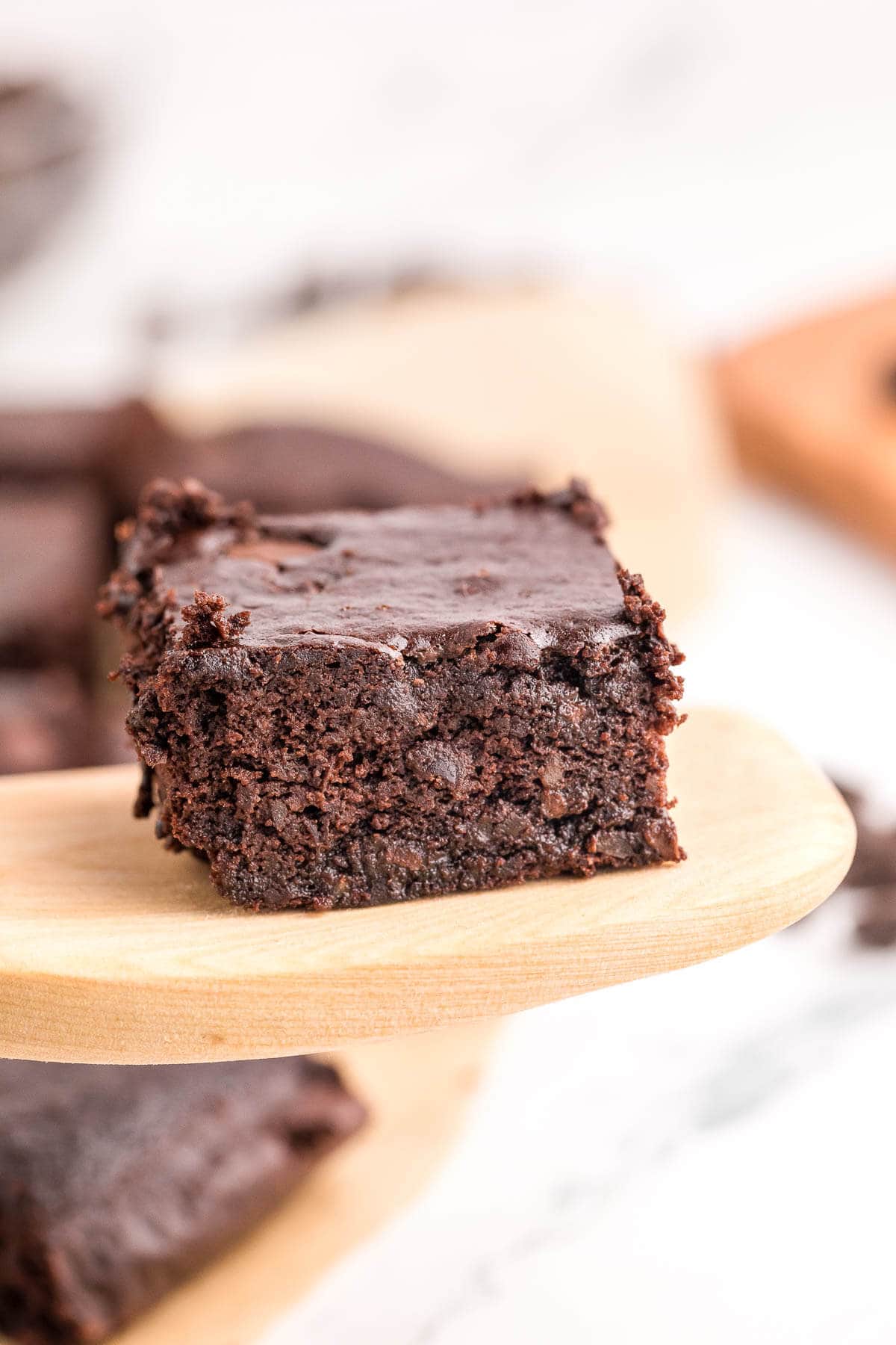 a single brownie on a wooden plate