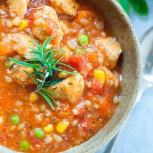 chick stew in bowl with rosemary garnish