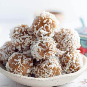 a bowl of date free bliss balls with coconut