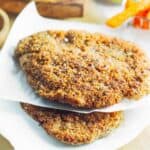 2 chicken schnitzels on parchment paper