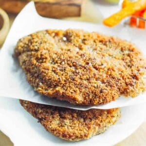 2 chicken schnitzels on parchment paper