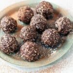 nut free bliss balls scattered on a plate