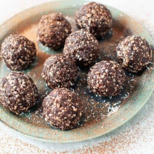 nut free bliss balls scattered on a plate