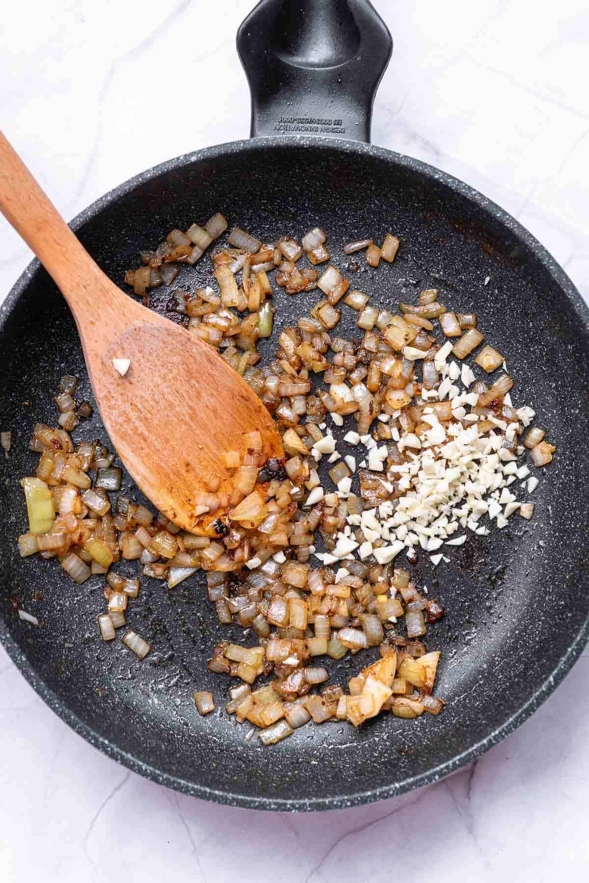 onions and garlic cooking in a skillet