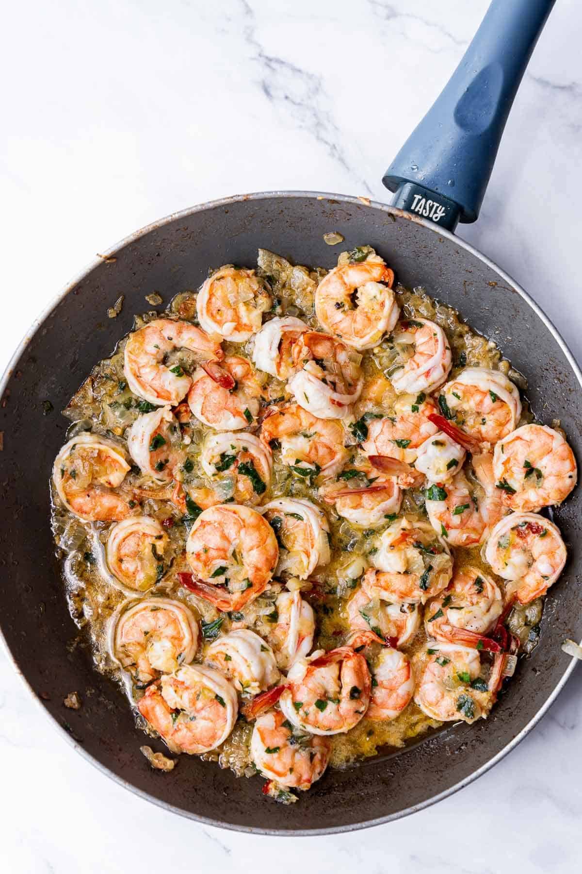 skillet with cooked prawns in garlic butter