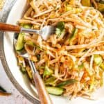fork digging into a bowl of cold kimchi salad noodles
