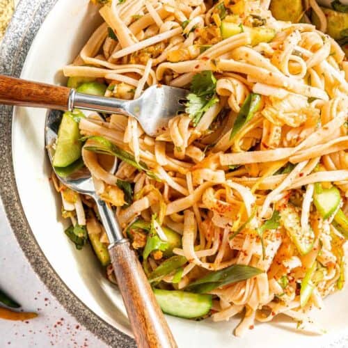 fork digging into a bowl of cold kimchi salad noodles