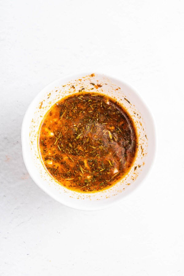 Chicken marinade in a white bowl