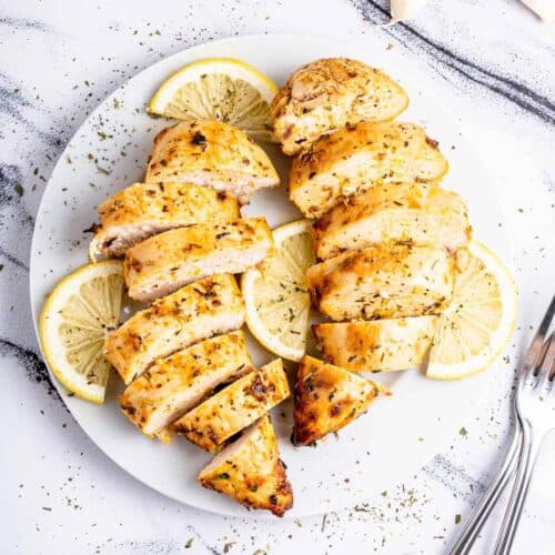2 sliced thin air fried chicken breasts on a plate