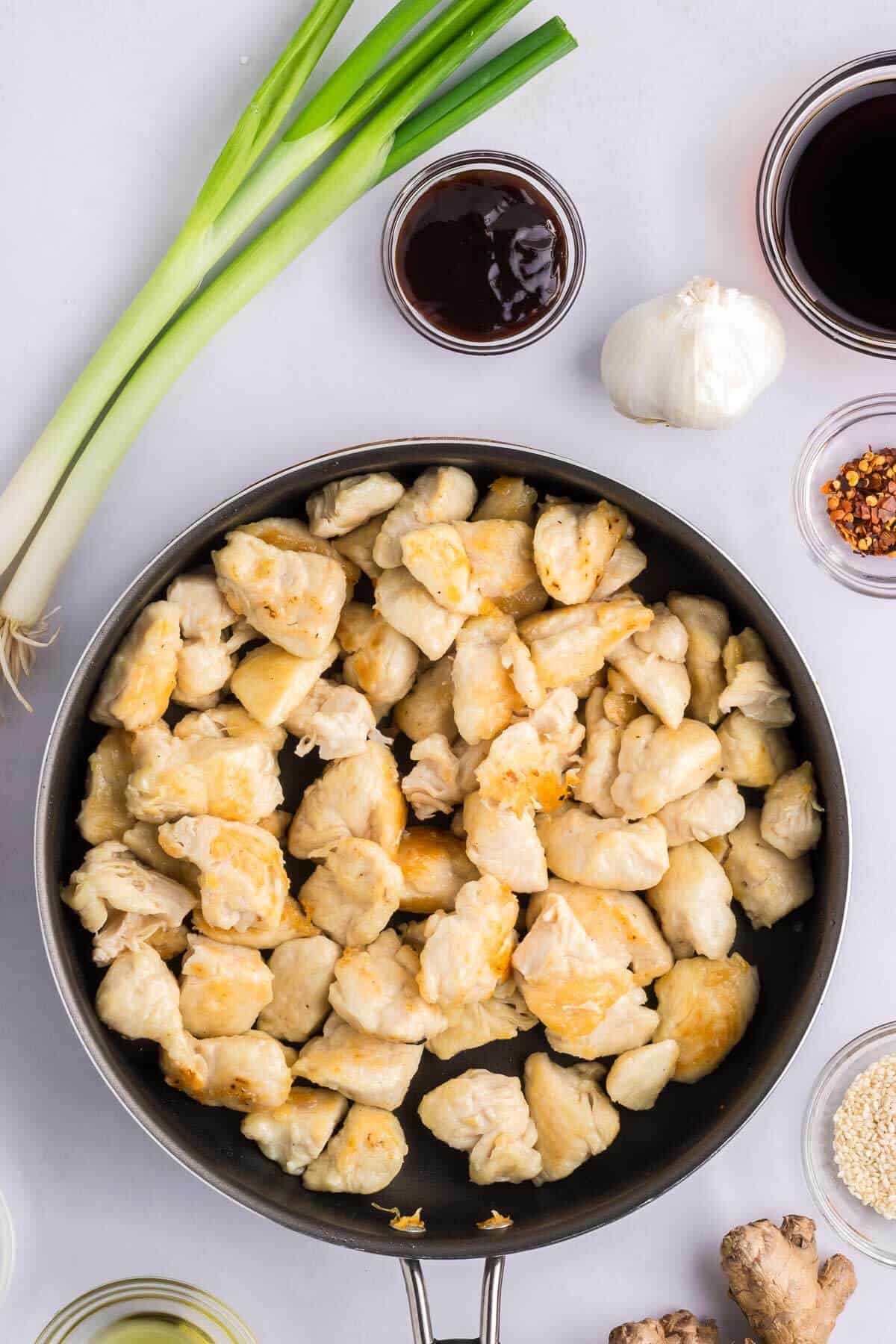 skillet with cooked chicken breast pieces