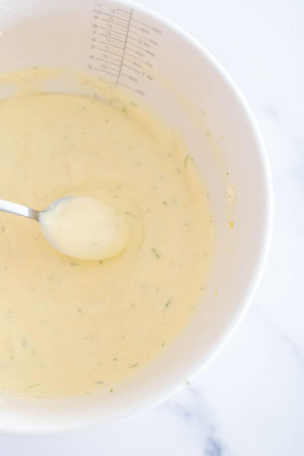 lime cheesecake filling in a bowl with spoon