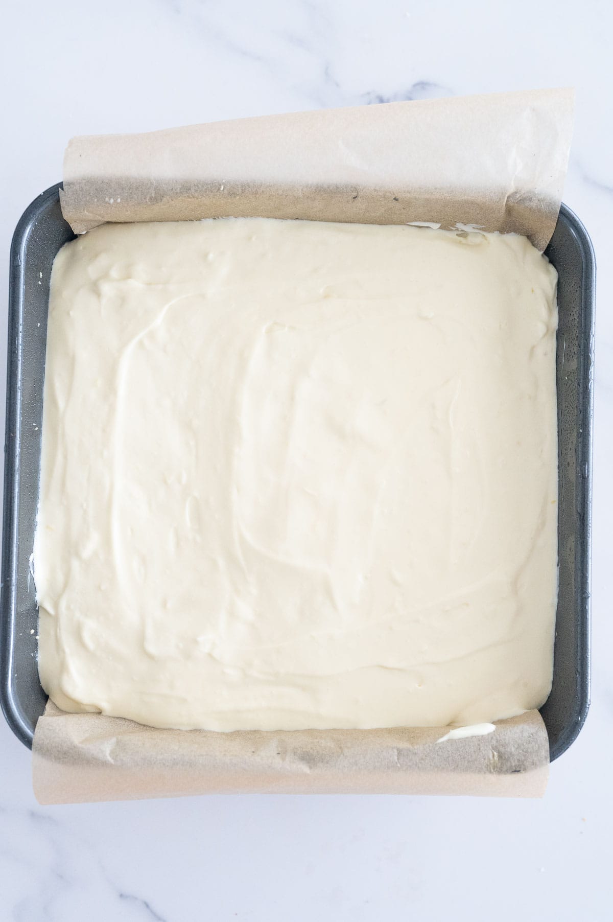 cheesecake filling poured into tin ready for oven