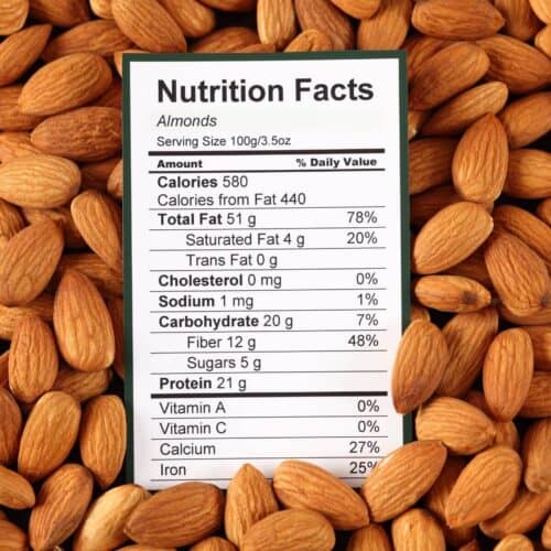 lots of almonds with a nutrition label on top